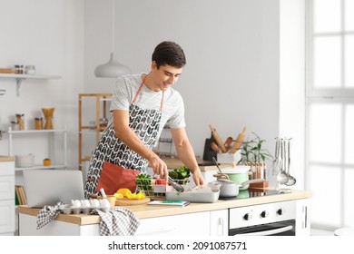 Young man cooking in kitchen - Powered by Shutterstock