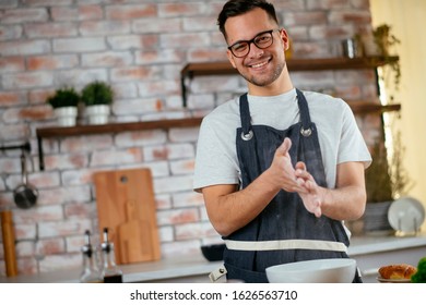 Young Man Cooking In The Kitchen. Home Chef Preparing A Great Meal.