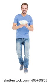 Young man counting currency notes on white background