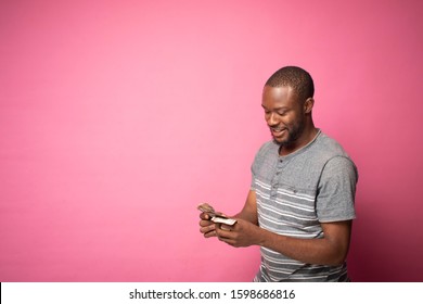 A Young Man Counting His Money Happily