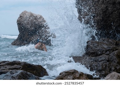 Young man is covered by a sea wave - Powered by Shutterstock