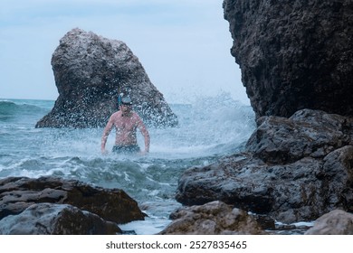 Young man is covered by a sea wave - Powered by Shutterstock