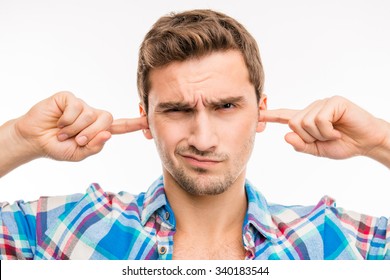 Young Man Covering His Ears Ignoring Noise