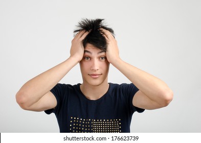 Young Man With Crazy Hair Holding His Head Confused. Bad Hair Day. Man With Different Facial Expressions.