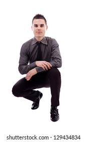 Young Man Crouching, In Full Length Pose, Isolated On White Background