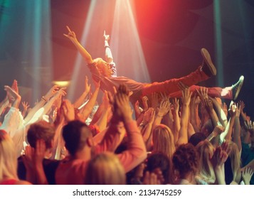 A Young Man Crowd Surfing To His Favorite Band. This Concert Was Created For The Sole Purpose Of This Photo Shoot, Featuring 300 Models And 3 Live Bands. All People In This Shoot Are Model Released.