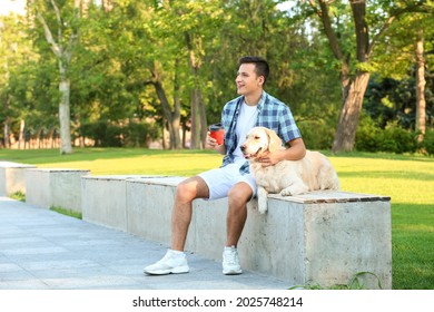 Young Man With Cute Dog Walking Outdoors