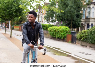 Young Man Cycling To Work