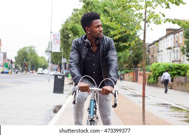 Young Man Cycling To Work