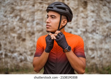 Young man cyclist wearing his sports helmet outdoor