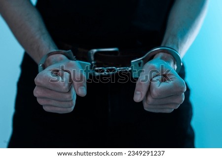 Young man desperate to catch the iron prison,prisoner concept,Handcuffed hands of a prisoner in prison, Male prisoners were severely strained in the dark prison, violence, 