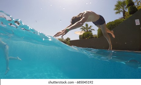 young man diving into a swimming pool