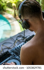 Young Man DJ Is Playing Music At The Pool Party.