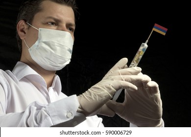 Young Man As A Doctor Gives A Medical Injection To Armenian Flag On A Black Background