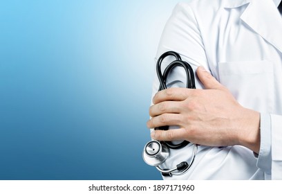 Young man doctor holding a stethoscope on background