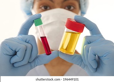 Young Man Doctor  Holding A Urine And Blood Sample 