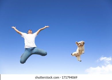 young man and dog jumping in the sky