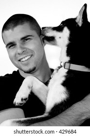 Young Man With Dog Licking His Face