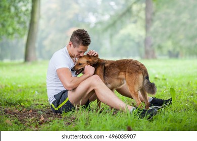 Young Man With Dog In Park