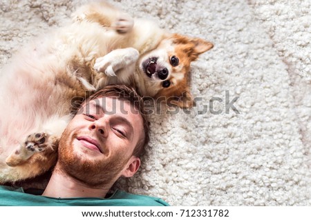 the young man with a dog is played. close up portrait