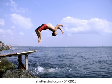 Young Man Doing A Back Flip Into Sea, Istanbul, Turkey