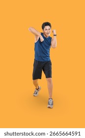Young man doing boxing poses with focused expression on a orange background	
