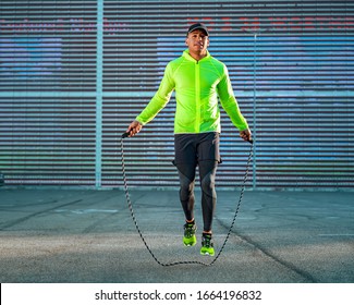 Young man doing cardio with a skipping rope outdoors. Healthy lifestyle - Powered by Shutterstock