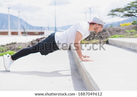 Similar – Athlete at the city park warming and stretching