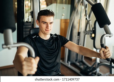 Young Man Doing Fitness Exercises On Home Gym Chest Press Machine.Making An Effort And Training For Fit Toned Summer Body Shape.Home Workout.Weight Loss Supplements.Dedication,motivation,diet