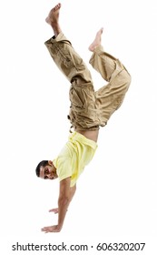 Young man doing handstand, looking at camera
