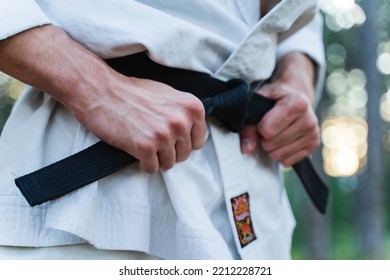 A young man doing karate in the forest training strength pose meditation  - Powered by Shutterstock