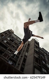 Young Man Doing Parkour Jump In The City   Spring  Day 
