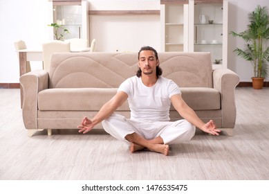 Young man doing physical exercises at home - Shutterstock ID 1476535475