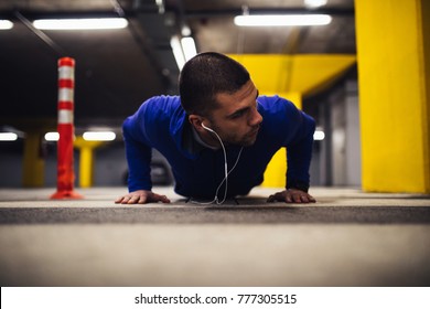 Young Man Doing Pushups Indoors