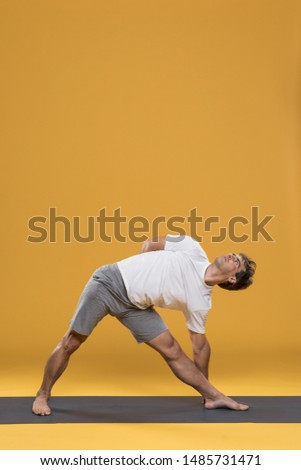 Mexican yoga teacher practicing side angle pose