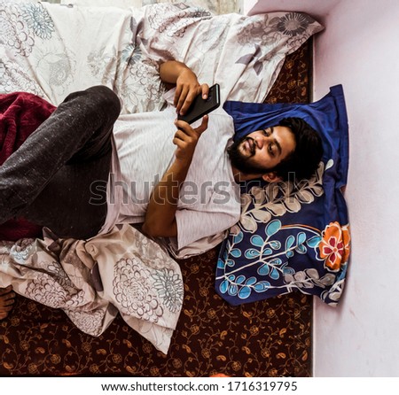 Young man doing timepass alone in the room beacuse for lockdown