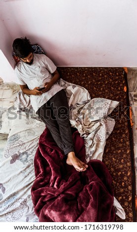 Young man doing timepass alone in the room beacuse for lockdown
