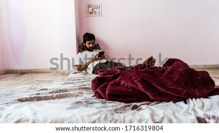 Young man doing timepass alone in the room beacuse for lockdown