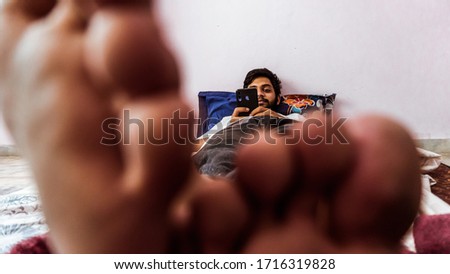 Young man doing timepass alone in the room beacuse for lockdown