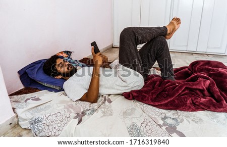 Young man doing timepass alone in the room beacuse for lockdown