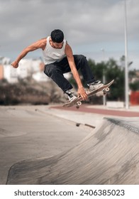 young man doing a trick called boneless in a ramp of a skate park. movement 3