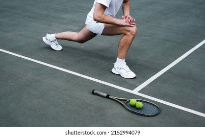 young man doing a warm-up on the sports ground before playing tennis - Shutterstock ID 2152994079