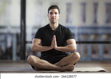 Young Man Doing Yoga In Office