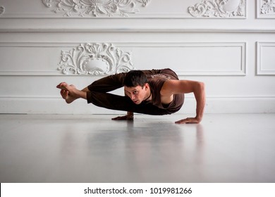 Young Man Doing Yoga In Studio. Healthy Lifestyle. Fitness Workout. Lotus Position And Other Asanas For Reaching Harmony Inside Body And Beauty Outside. Handsome And Sexy. Warrior Pose Is His Beloved.