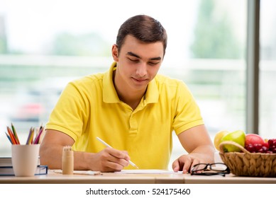 Young Man Drawing Pictures In Studio