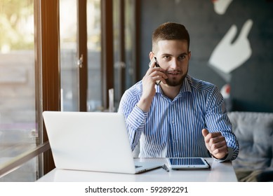 Young man drawing template for the web site associated with digital marketing, current trends and tendencies of UX / UI design. Businessman who rules his company remotely, like a freelancer.  - Shutterstock ID 592892291