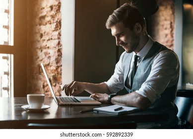 Young man drawing template for the web site associated with digital marketing, current trends and tendencies of UX / UI design. Businessman who rules his company remotely, like a freelancer. 