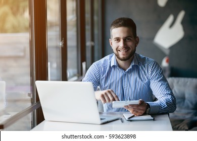 Young man drawing template for the web site associated with digital marketing, current trends and tendencies of UX / UI design. Businessman who rules his company remotely, like a freelancer - Shutterstock ID 593623898