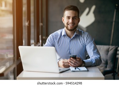 Young Man Drawing Template For The Web Site Associated With Digital Marketing, Current Trends And Tendencies Of UX / UI Design. Businessman Who Rules His Company Remotely, Like A Freelancer