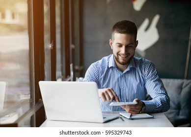 Young man drawing template for the web site associated with digital marketing, current trends and tendencies of UX / UI design. Businessman who rules his company remotely, like a freelancer - Shutterstock ID 595329743